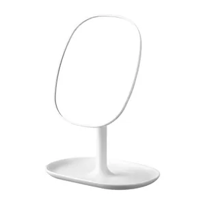 Minimalist white desktop makeup mirror with rotatable stand and oval storage base tray
