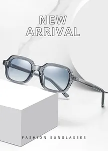 Stylish small frame propionate sunglasses with gradient blue lenses on white podium.
