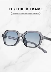 Close-up of high-end grey textured frame sunglasses with UV protection gradient lenses