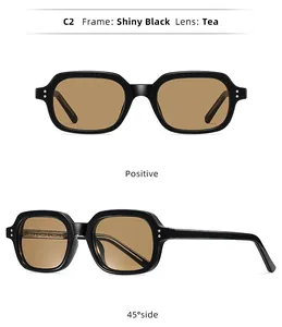 Detail view of stylish small frame sunglasses with shiny black frame and tea lenses