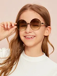 Close-up of a smiling girl wearing cute flower-shaped rimless sunglasses for kids.