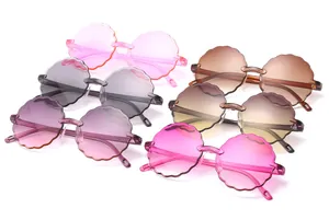 Detailed view of kids rimless sunglasses featuring cute flower-shaped scalloped lenses.