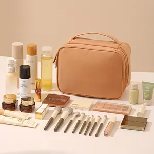 Large brown oxford fabric makeup bag for travel shown with various cosmetic products