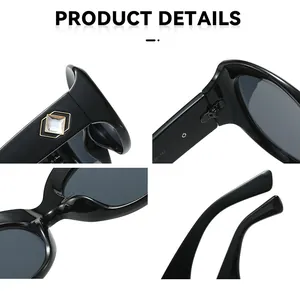 Close-up of black oversized sunglasses showing rhinestone detail and metal hinges.