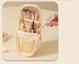 Close-up detail view of the standing makeup brush bag interior showing organized brushes and mesh pocket