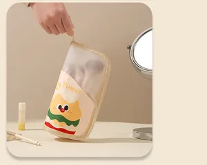 Close-up of portable cartoon makeup brush storage bag with cute burger character