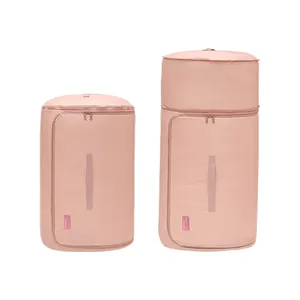 Durable set of two pink compressible cylindrical storage bags for quilts and bedding items