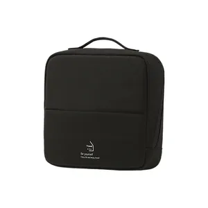 Minimalist black travel cosmetic bag with handle and large capacity multi-layer storage