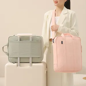 Large capacity travel storage bag with luggage strap shown in pink and green colors