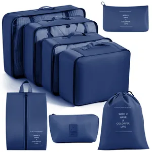 Set of 7 navy blue travel luggage organizers including packing cubes and laundry bags