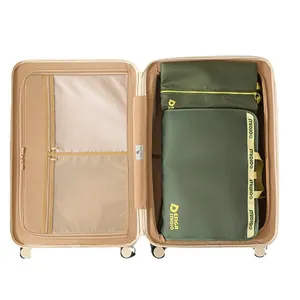 Olive green travel clothing organizer bags set neatly packed inside a beige suitcase.