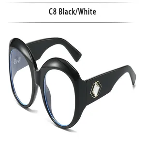 Close-up of oversized round black glasses frame featuring diamond-shaped side decoration