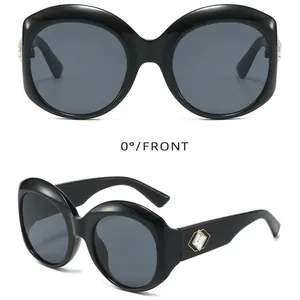 Oversized black round sunglasses featuring decorative crystal on temple for UV protection