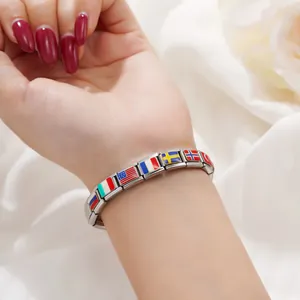 Detail view of a stainless steel modular charm bracelet with national flag designs.