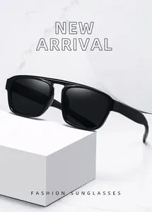 Detailed view of modern double-bridge sunglasses for men on a minimalist marble backdrop.
