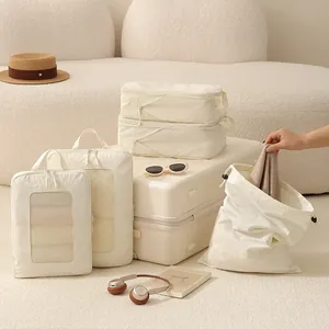 Set of cream compression travel packing cubes with Taslon mesh organizers for luggage