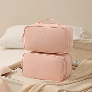 Large capacity pink Taslan underwear storage bags stacked in a travel suitcase