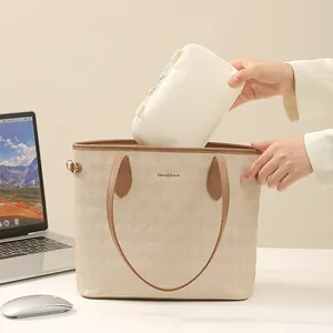 Beige quilted tote bag with matching storage pouch for travel and digital accessories