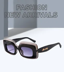 Detailed side view of retro square sunglasses with purple lenses and gold logo engraving.