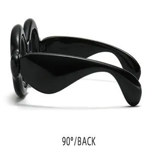Side view detail of trendy black bubble-style frog eye sunglasses for street wear