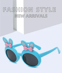 Detail view of light blue children's sunglasses with cute bunny ears and pink bows.