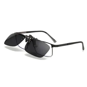 Polarized flip-up clip-on sunglasses for driving with metal frame on white background.