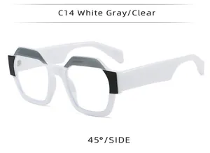 Detailed side view of trendy polygonal square eyeglasses in white, gray, and clear.