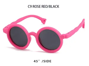 Detailed 45-degree side view of rose red round kids polarized sunglasses in silicone