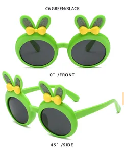 Detailed view of children's green bunny ear sunglasses with cute yellow bows for girls