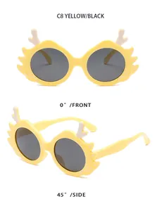 Yellow cartoon dragon horn kids sunglasses with black lenses shown from front and side angles