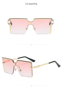 Detailed view of children's metal semi-rimless sunglasses with gold frames and pink lenses.