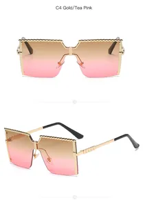 Detailed macro view of gold metal children's sunglasses with stylish tea pink gradient lenses.