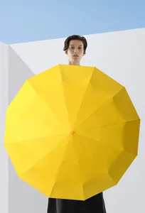 Close-up of large yellow umbrella with sturdy 72-rib frame against blue sky
