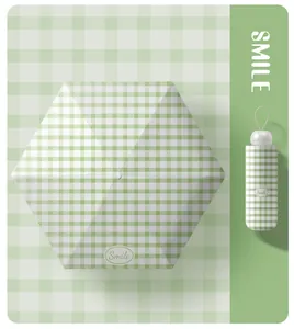 Mini green gingham foldable umbrella with a matching compact capsule carrying case for sun