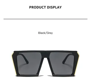 Detailansicht einer übergroßen quadratischen Sonnenbrille mit schwarzem Rahmen und Gold