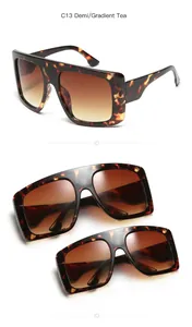 Detailed view of oversized tortoiseshell sunglasses set with gradient brown lenses.
