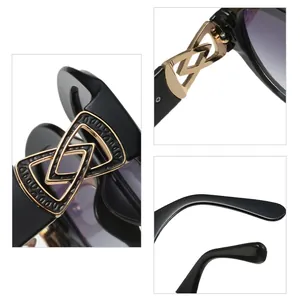 Detailed macro view of stylish black round sunglasses with golden geometric temple accents