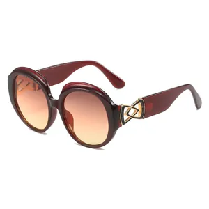 Elegant oversized round sunglasses for women with red gradient lenses and gold accents