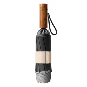 Automatic windproof folding umbrella with black UV canopy and wood-grain handle