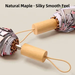Detailed view of folded Chinese style floral umbrellas with natural maple wood handles
