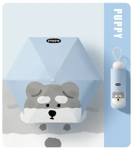 Close-up of cute puppy face pattern on light blue compact umbrella with matching case
