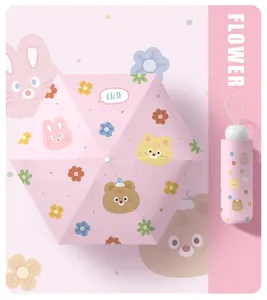 Detailed view of mini pink folding umbrella with cute animal and flower patterns