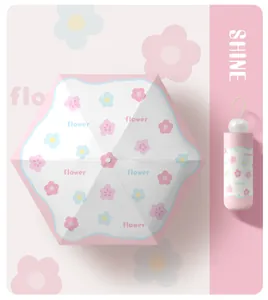 Pink floral capsule umbrella shown in open top view and folded compact version