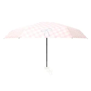 Compact and portable pink checkered folding sun umbrella with UV protection and bow detail