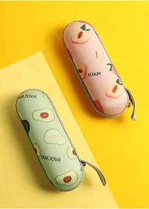 Detail view of portable capsule cases for five-fold umbrellas in avocado and peach patterns