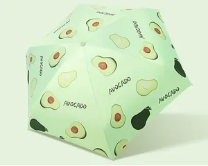 Close-up of lightweight five-fold umbrella with cute green avocado pattern print