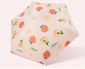 Detailed view of pink umbrella canopy with cute peach print and PEACH lettering