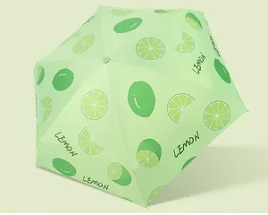 Close-up detail showing the refreshing lemon fruit pattern on a light green umbrella