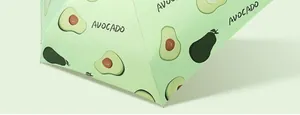 Close-up of cute avocado fruit pattern on light green sun umbrella fabric