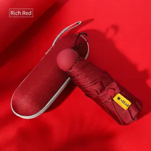 Compact five-fold capsule sun umbrella in rich red with UPF50+ protection and matching case